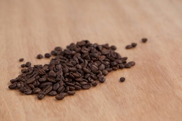 Fototapeta na wymiar Coffee beans on wooden table
