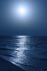 Fantastic blue sea background. Mediterranean Sea at night. Moon reflecting in a sea