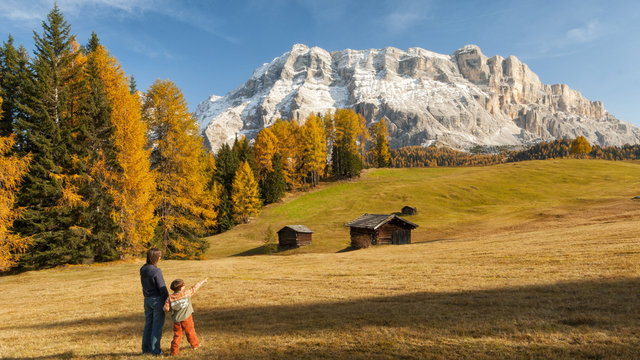 Mother and child admiring the Dolomite's autumn landscape, Prati dell'Armentara,Badia Valley, Italy
