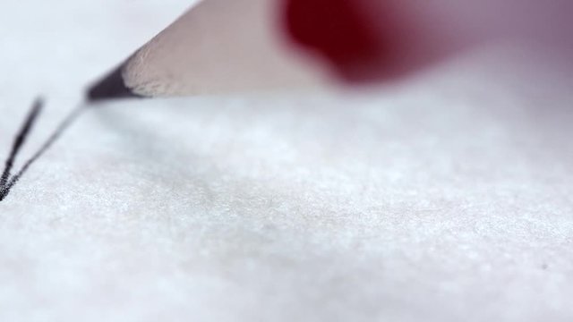 Drawing with a pencil in a macro shot on plain paper