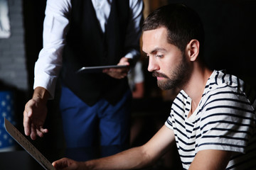 Waiter taking order from visitors in cafe