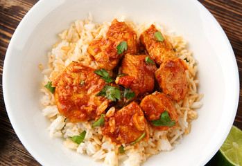 Plate with tasty chicken tikka masala and rice, closeup