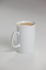 White mug of coffee with creamy froth