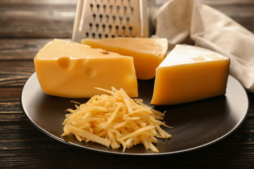 Delicious cheese and grater on table