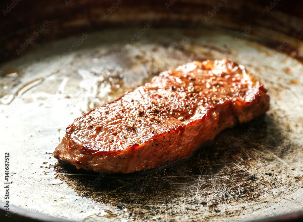 Sticker Delicious juicy steak on frying pan, closeup