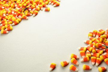Colorful Halloween candies on light background