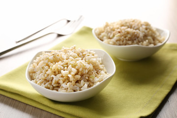 Two bowls of brown rice on napkin