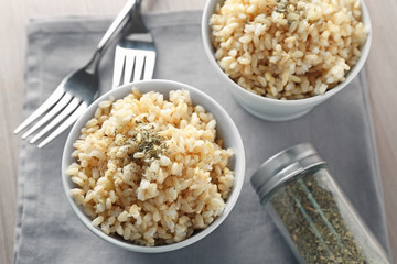 Two bowls of brown rice on napkin