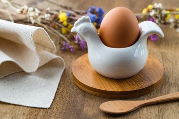 Egg, flowers on wooden background. Easter table