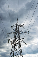 High voltage electricity pylon against cloud. Electric pole power lines and wires.