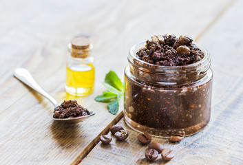 Organic scrub from ground coffee with oil on wooden table background
