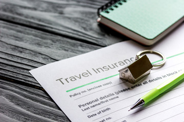 Travel preparation concept with insurance on wooden table