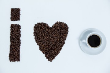 Coffee beans and cups forming I love, addiction coffee