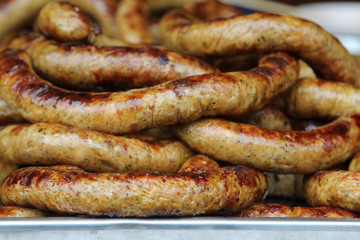 Thai food, grilled Thai sausages Northern style on stove at market.