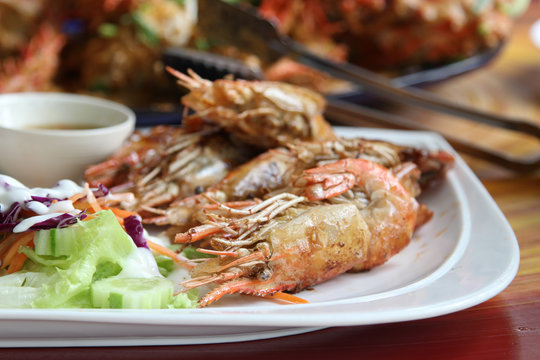 Thai food, fried prawns with salt and chili serve with fresh vegetable salad dressed with mayonnaise.
