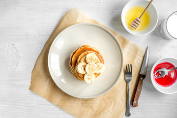 cooked pancake on plate top view at wooden background