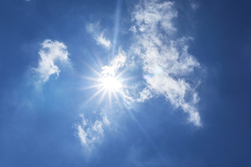 Naklejka na ściany i meble sun shining down from a clouded sky with sunflare