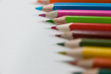 Close-up of colored pencils arranged in a row