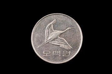 A Close Up Image Of A 500 Won Korean Coin On A Black Background