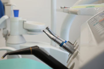 Closeup of metallic dentist tools and drills in dentistry clinic