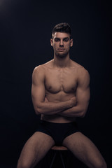 Fototapeta premium one young man, shirtless body posing sitting