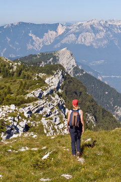 Hiker on the top of Manderiolo mount, in the background the Valsugana, Asiago, Italy