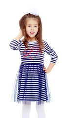 Cute little girl posing in front of the camera.