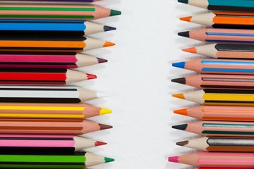 Close-up of colored pencils arranged in a row