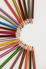 Colored pencils arranged in a semi-circle