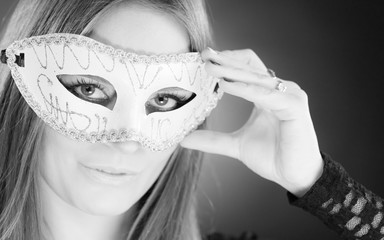 Woman holding carnival mask closeup
