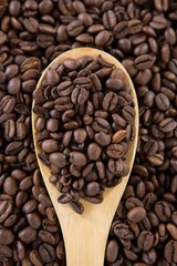 Roasted coffee beans with wooden spoon