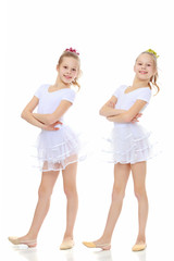 2 girls gymnast in white suits.