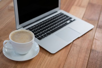 Fototapeta premium Cup of coffee and laptop