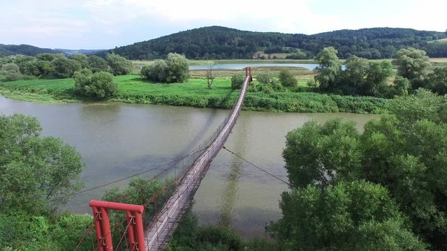 Aerial Of Suspension Footbridge Over River