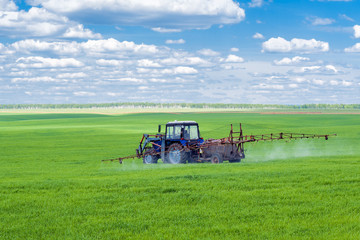 Tractor spraying a farm field
