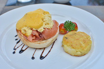 Egg benedict with sauce and smoked salmon