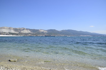 Sea bay landscape Tsemess. Mountains and clouds in the sky. In the distance can be seen the Marine cargo port