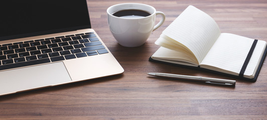 Office desk with laptop and coffee cup