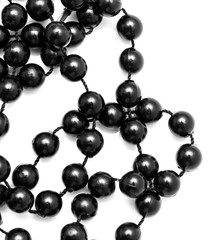 Black beads on a white background