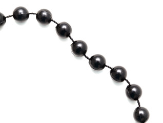 Black beads on a white background