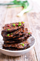 Fritters of liver.  Pancakes from the liver.  Food photo. Wooden background.