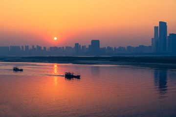Fototapeta premium sunset view of cityscape along riverside,located in China.