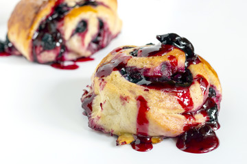 Homemade sweet baked roll with honeyberry preserve on white background