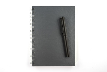Black pen and blank notebook isolated on white background