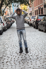 Fototapeta na wymiar A young, black hipster poses for a candid photograph in NYC
