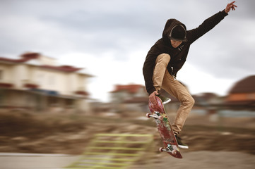 Close up of a skateboarders feet while skating active performance of stunt teenager shot in the air on a skateboard in a skate park © yanik88