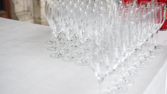 Catering preparation before the wedding, putting down flutes for  the welcome drink, 4K