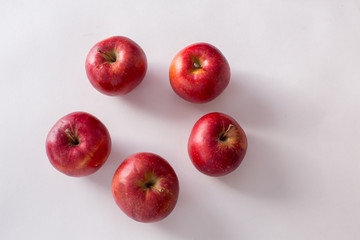 Red and green apples on a white background