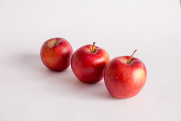 Red and green apples on a white background