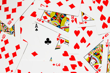 Black club card difference on red heart and diamond poker background